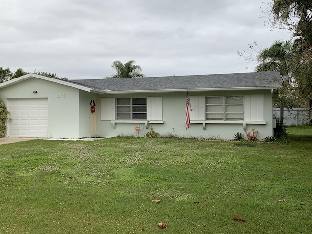 ranch-style home with a garage and a front lawn