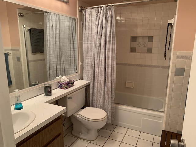 full bathroom with tile patterned flooring, shower / bath combination with curtain, toilet, and tile walls