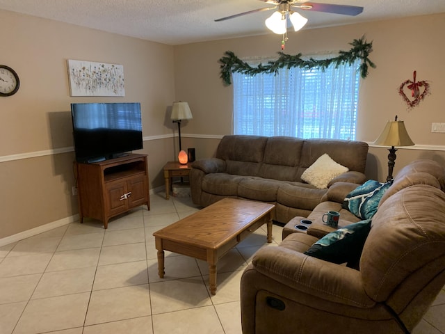 tiled living room with ceiling fan and a textured ceiling