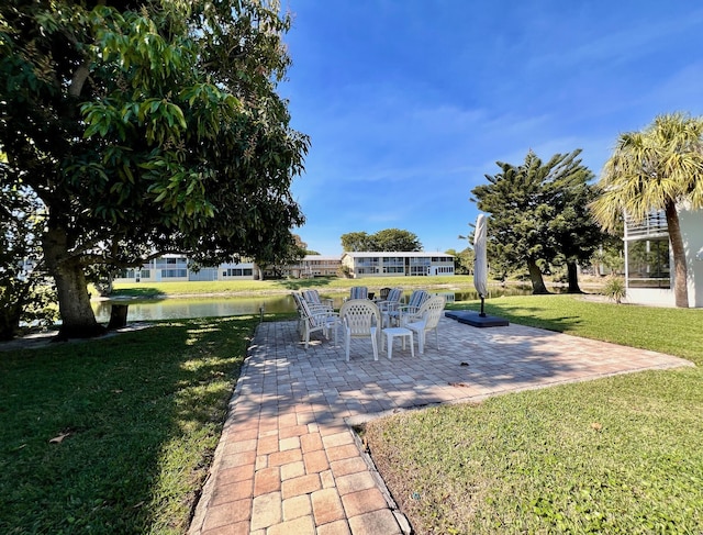 view of yard featuring a patio area and a water view