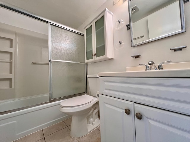 full bathroom with shower / bath combination with glass door, vanity, tile patterned floors, and toilet