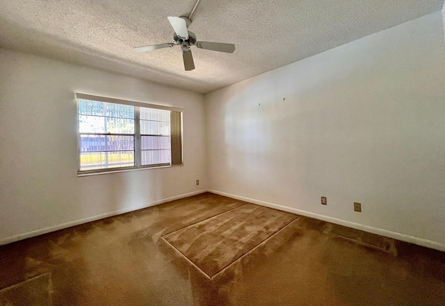 carpeted spare room with ceiling fan and a textured ceiling