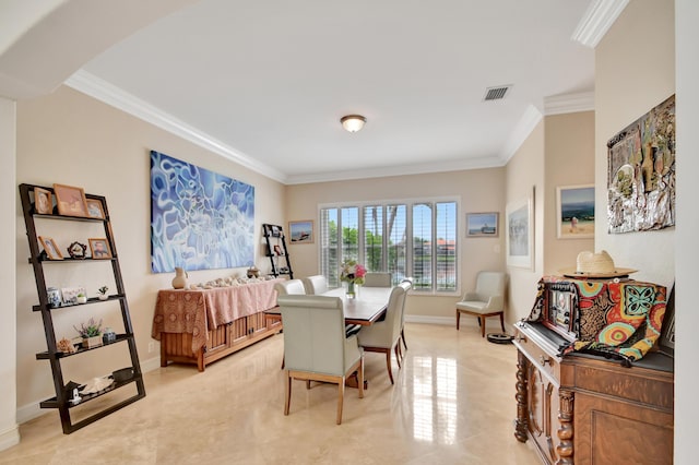 dining room featuring crown molding