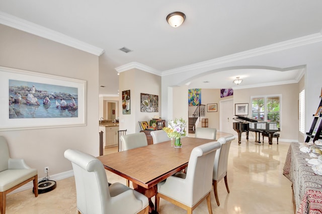 dining space with crown molding