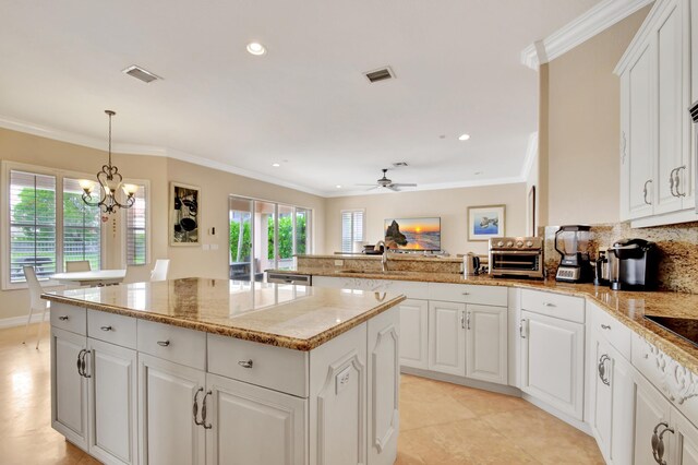 tiled dining area with crown molding and a notable chandelier