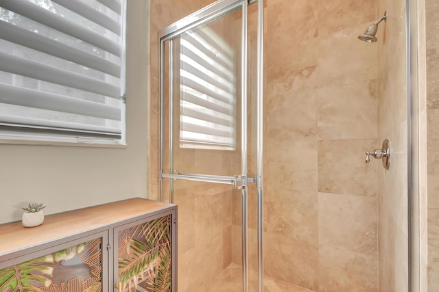 bathroom with a shower with shower door