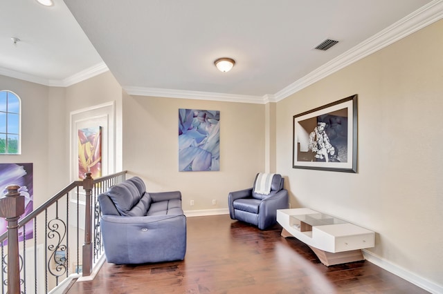 living area with dark hardwood / wood-style flooring and crown molding