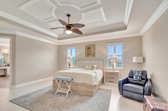 bedroom featuring a tray ceiling, ceiling fan, crown molding, and light hardwood / wood-style floors