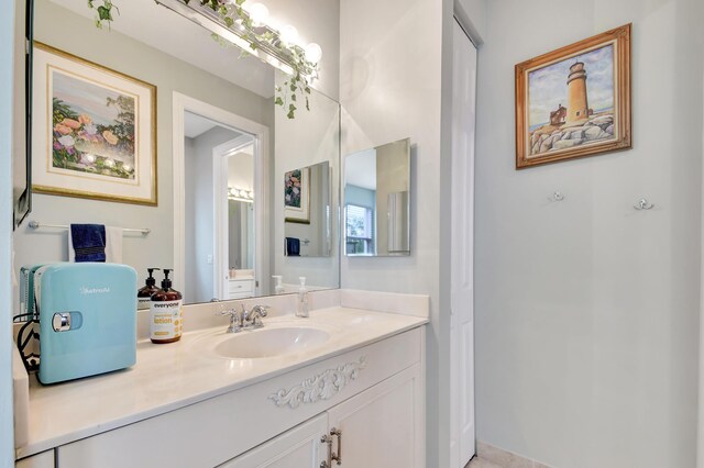 bathroom featuring tile patterned flooring and vanity