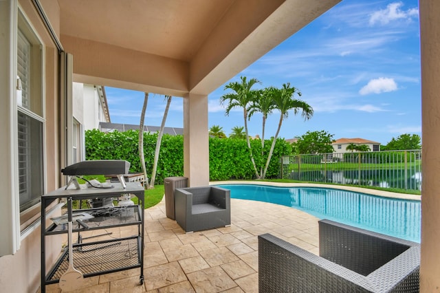 view of swimming pool with a water view and a patio