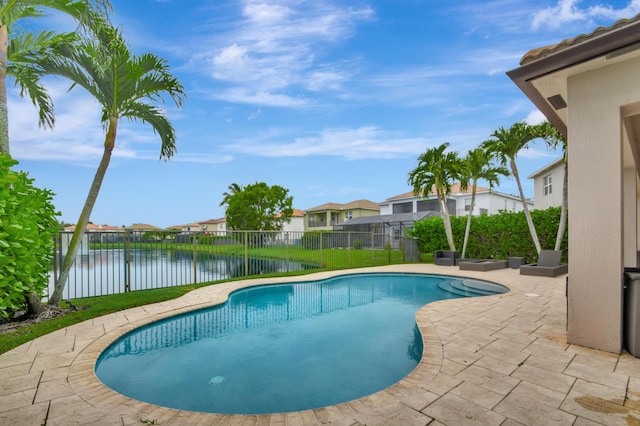 view of pool featuring a patio and a water view