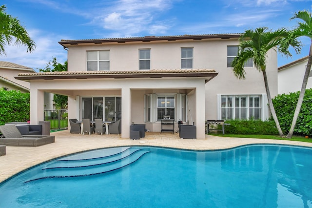 back of house featuring a patio area and an outdoor hangout area