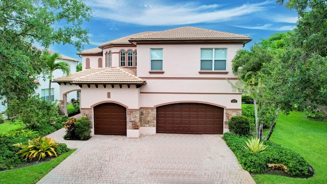 mediterranean / spanish-style house with a garage