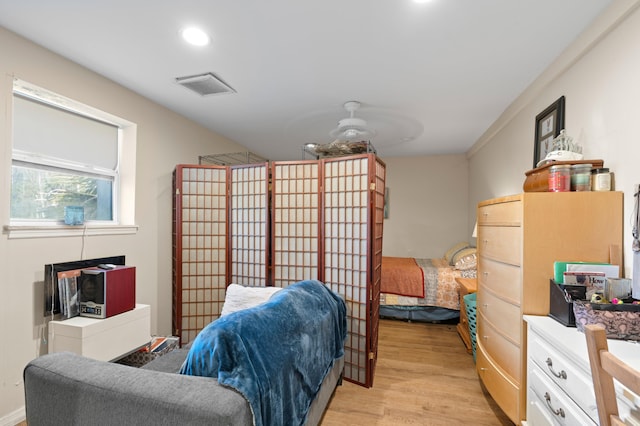 bedroom featuring ceiling fan and light hardwood / wood-style floors