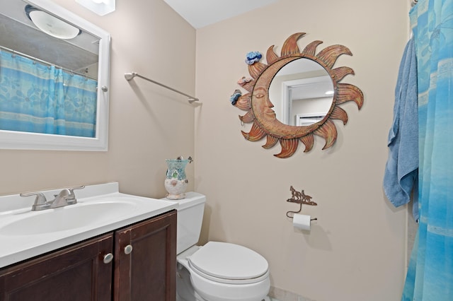 bathroom featuring toilet and vanity