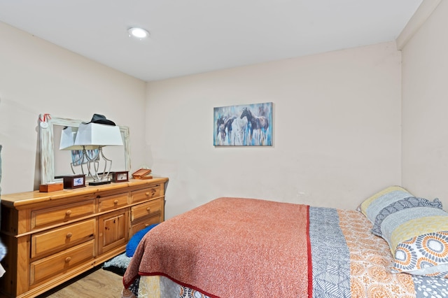 bedroom with hardwood / wood-style floors