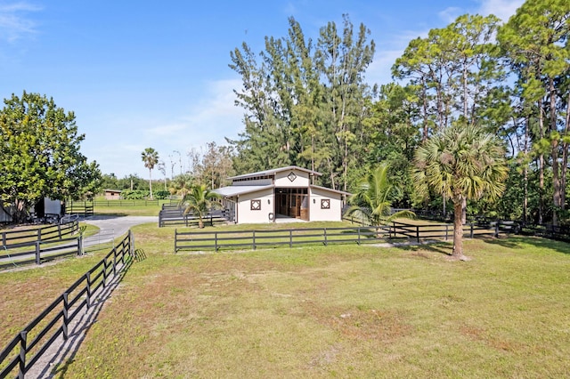 view of yard featuring a rural view and an outbuilding