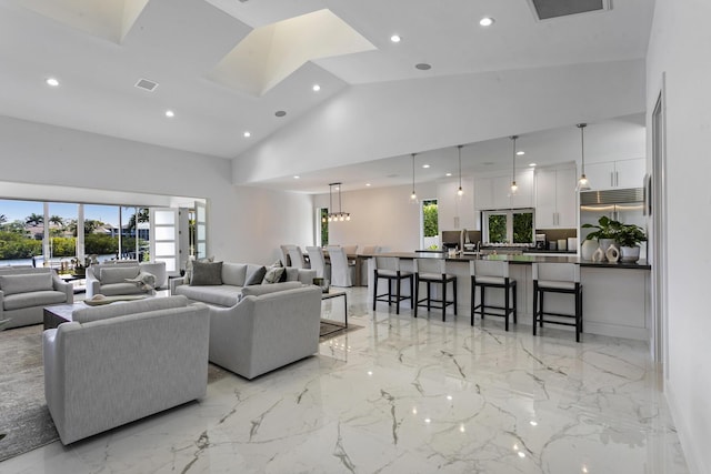 living room featuring high vaulted ceiling