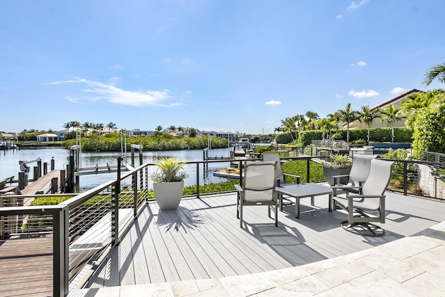 wooden terrace featuring a water view and a boat dock