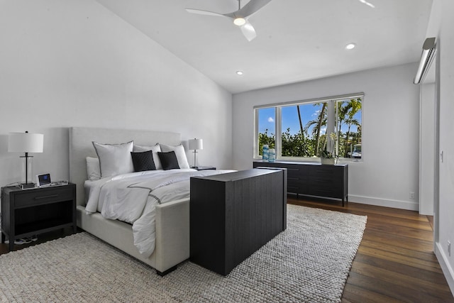 bedroom with vaulted ceiling, dark wood-type flooring, and ceiling fan