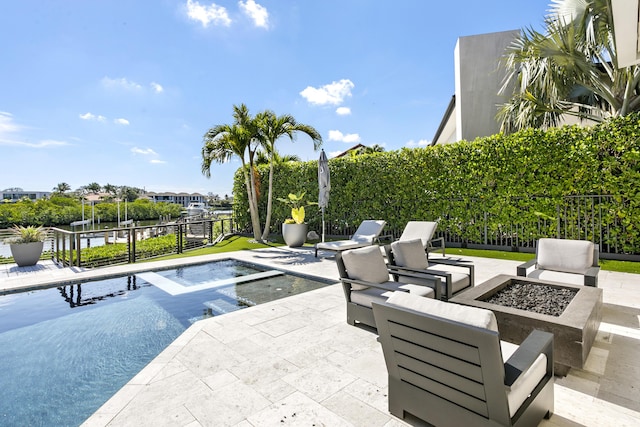 view of swimming pool featuring a fire pit and a patio area