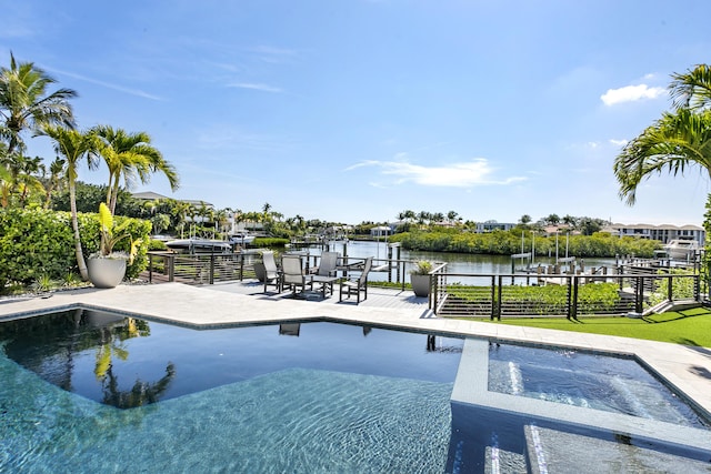 view of pool featuring a patio area, an in ground hot tub, and a water view