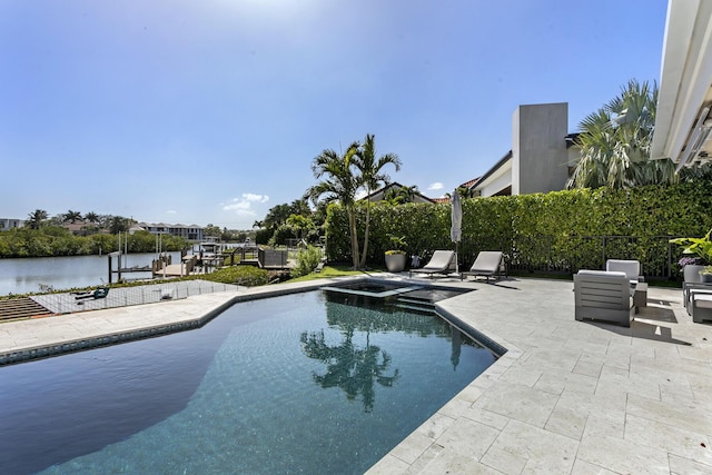 view of swimming pool with an in ground hot tub, a patio, and a water view