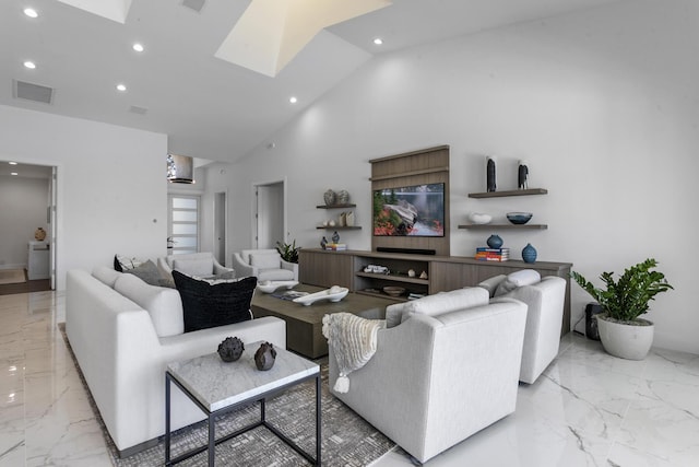 living room featuring a skylight and high vaulted ceiling