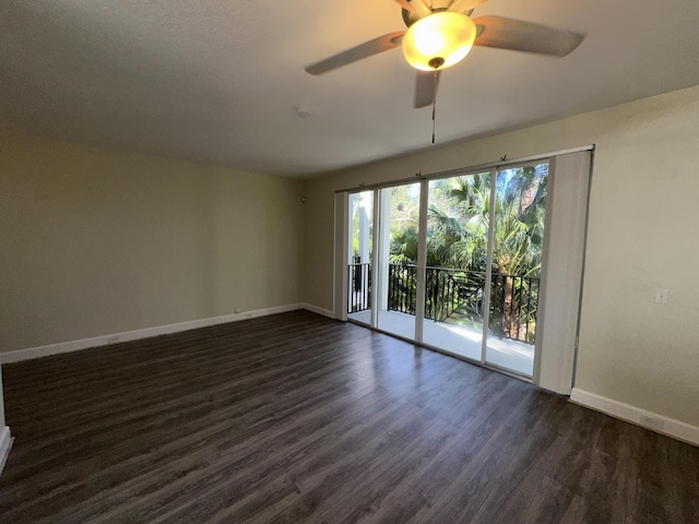 unfurnished room featuring ceiling fan and dark wood-type flooring