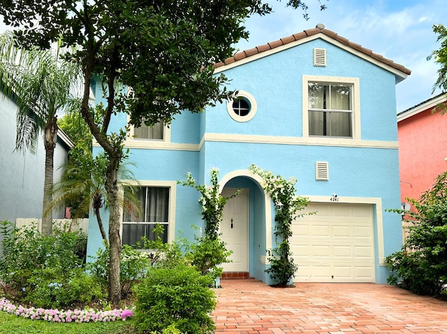 mediterranean / spanish home featuring a garage