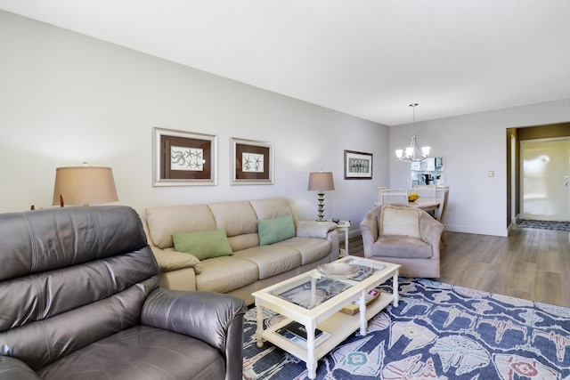 living room featuring a notable chandelier and wood-type flooring