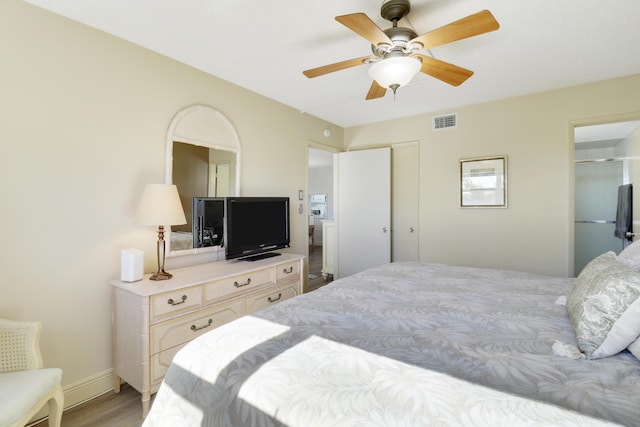 bedroom with ceiling fan, light hardwood / wood-style floors, and a closet