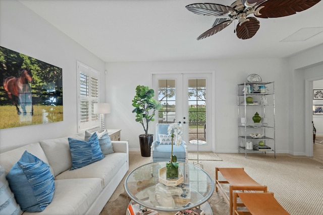 living room featuring a healthy amount of sunlight, french doors, and carpet floors