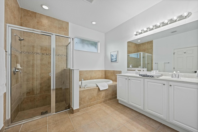 bathroom with tile patterned floors, vanity, and separate shower and tub