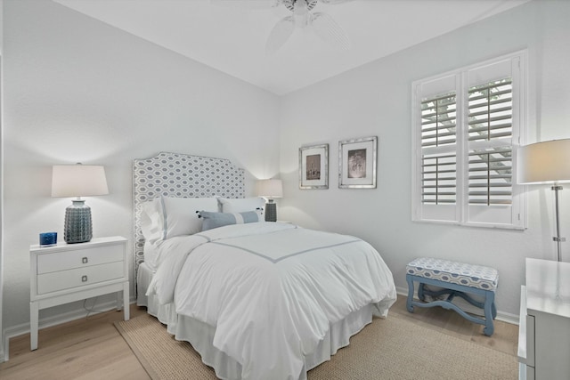 bedroom with ceiling fan and light hardwood / wood-style flooring