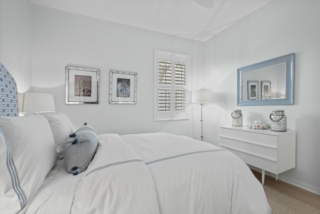 bedroom with ceiling fan and hardwood / wood-style floors