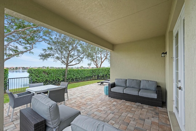 view of patio with a water view