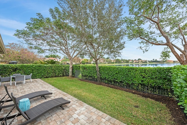 view of yard featuring a water view and a patio