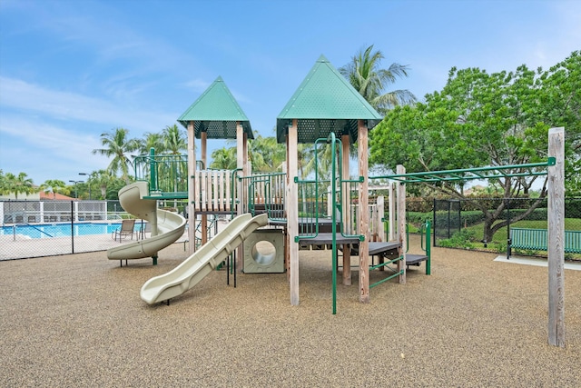 view of jungle gym with a community pool