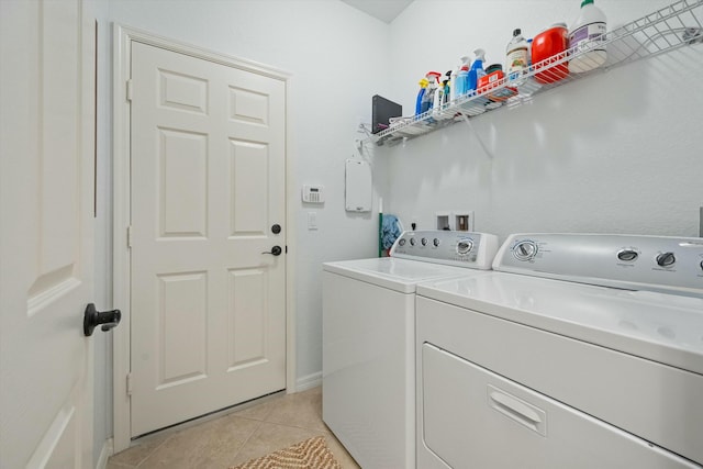 laundry room with light tile patterned floors and independent washer and dryer