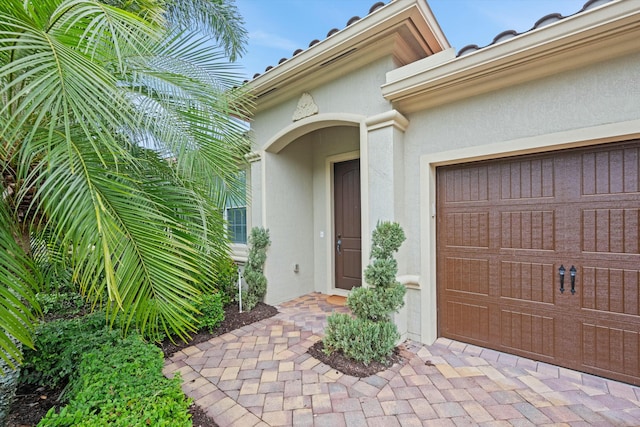 doorway to property with a garage