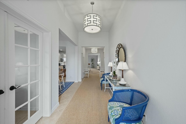 corridor with light tile patterned floors and french doors