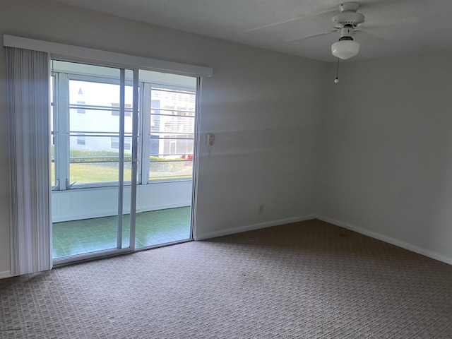 carpeted spare room with ceiling fan