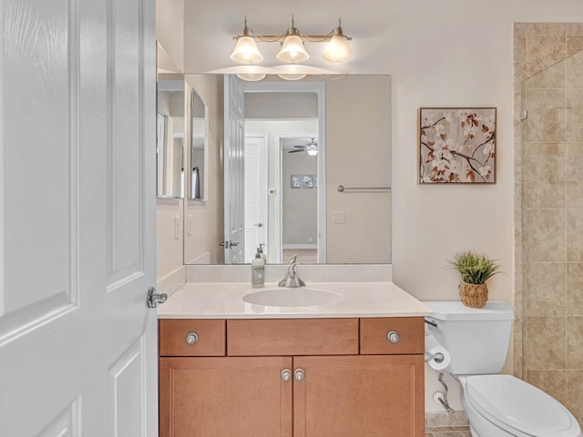 bathroom with ceiling fan, toilet, and vanity