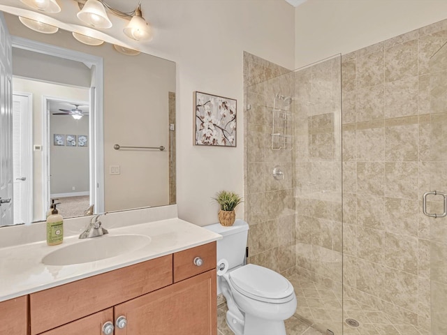 bathroom with ceiling fan, toilet, an enclosed shower, and vanity