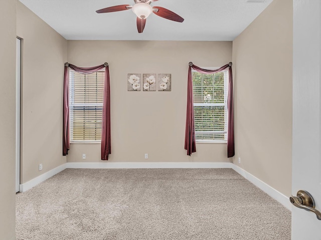 empty room with carpet flooring and ceiling fan