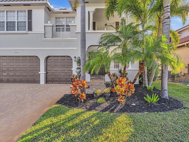 view of front of home featuring a balcony and a garage