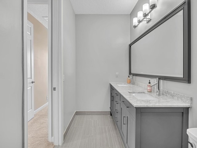 bathroom with vanity and a textured ceiling