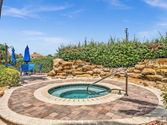 view of pool featuring an in ground hot tub and a patio