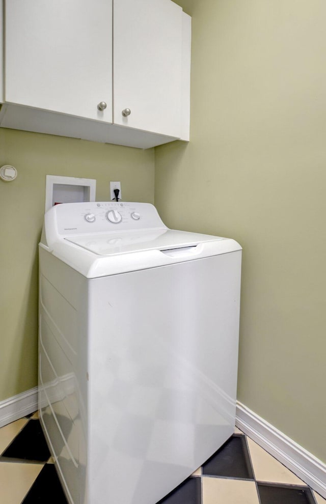 washroom with cabinets and washer / dryer